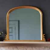 Amos Gold leaf arch over mantel mirror